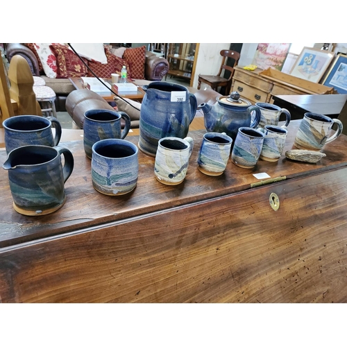 390 - Gorgeously rustic earthenware tea set in earthy blue tones, comprises 2 sizes of mugs, teapot and 2 ... 