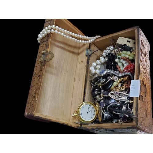 127 - A beautiful carved wooden jewellery box filled to the brim with assorted costume jewellery including... 