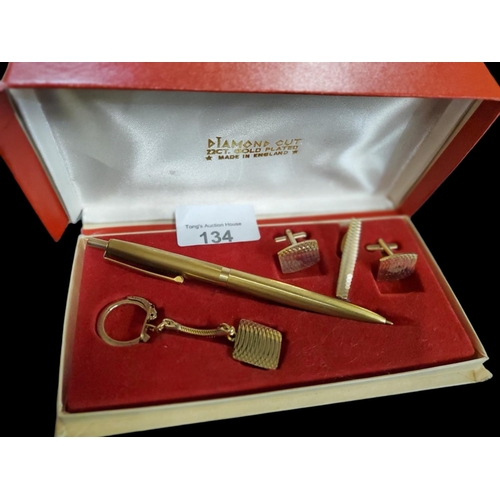 134 - Diamond cut 22ct gold plated pen, cufflinks and keyring set