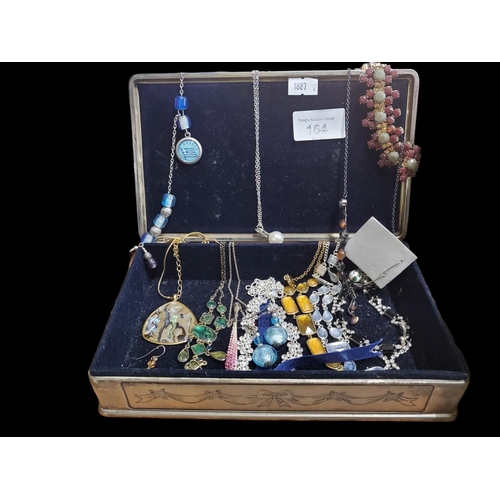 164 - A beautiful metal jewellery box with velvet lining filled with a number of very pretty necklaces and... 