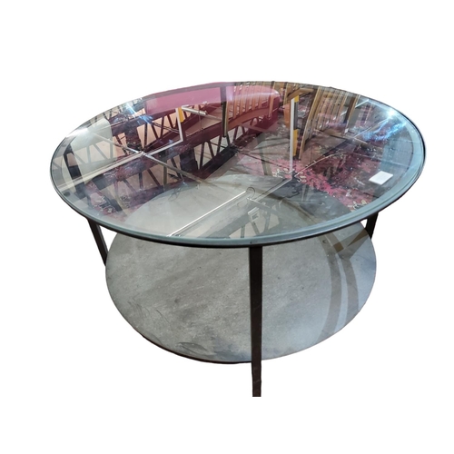 342 - Circular metal glass topped coffee table. Handy lower shelf 6 inches off the ground 
Approx size in ... 