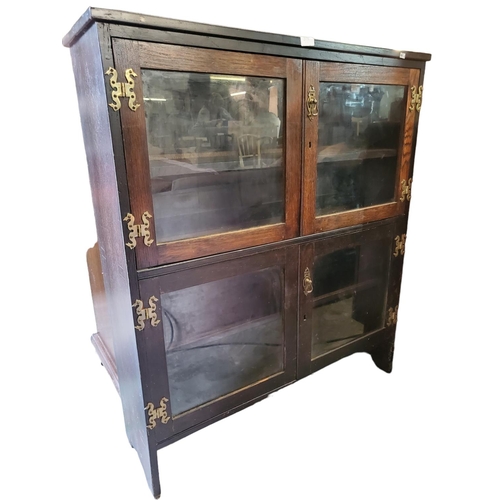 385 - Mahogany glass fronted double cupboard (internal shelf in both cupboards) with decorative hinges. Na... 