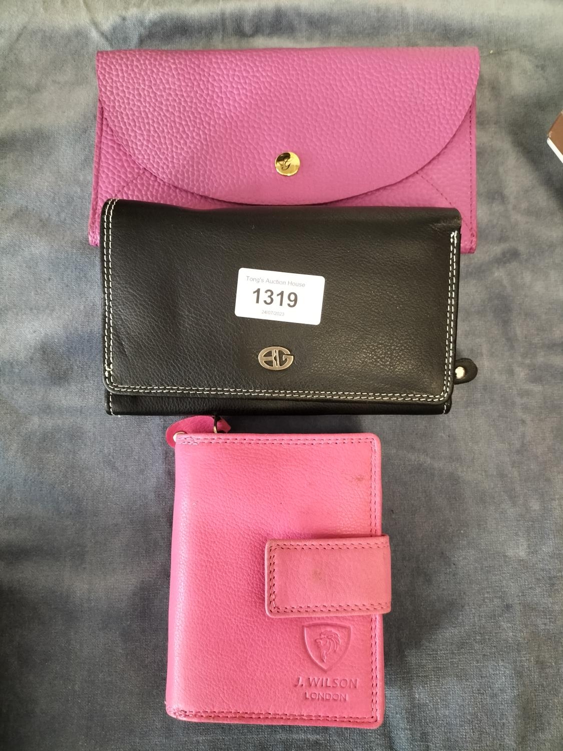 An assortment of 3 real leather purses 2 pink and one black