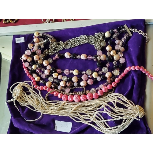 246 - A very nice selection of costume jewellery necklaces with a purple velvet bag