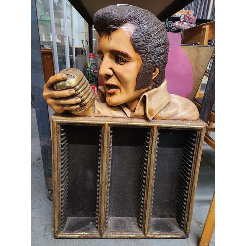 A fabulous CD rack with a carved image of Elvis Presley, the King 