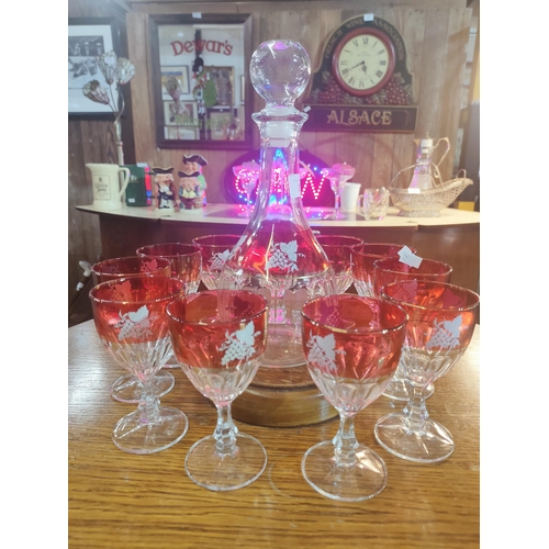 267 - Beautiful decanter set with 11 glasses with coloured rim and a grape vine decoration