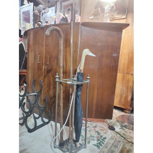 269 - Two vintage walking sticks and an umbrella with a carved duck head handle together with a metal stic... 