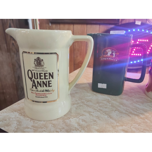 276 - Pair of vintage branded pub water jugs, one Queen Anne Scotch Whisky and the other Greenalls Brewery