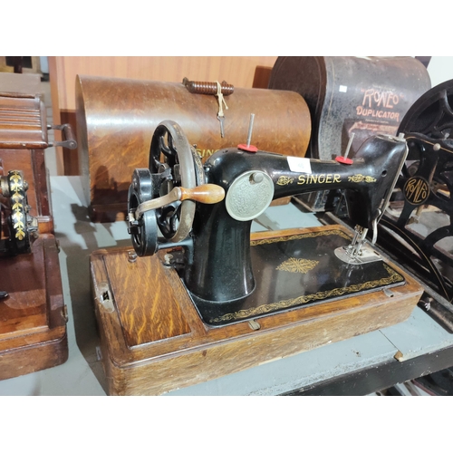 46 - A beautiful and elegant Singer sewing machine with original wooden plinth and wooden case.