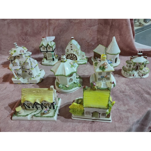 60 - Charming collection of Coalport bone china model houses including The Oast House, The Umbrella House... 