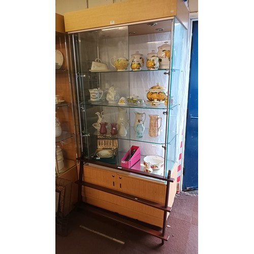 1118 - Large glass backed 4 shelf display case with lights and underneath storage cupboard, measures approx... 