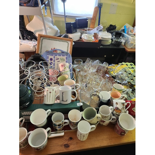 1239 - Massive job lot of kitchenalia including many mugs and glasses together with a metal bottle stand, t... 