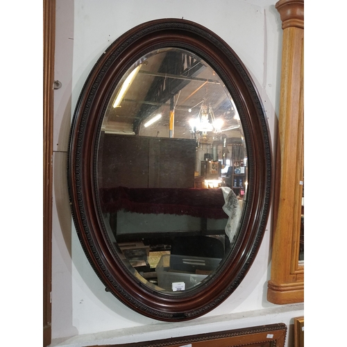 202 - Really lovely dark wood framed oval wall mounted mirror. 63 x 87cm