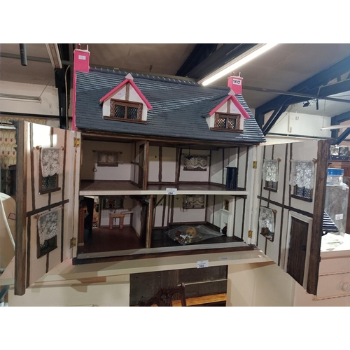 264 - Incredible tudor style dolls house with double front opening, beams on the ceiling, fireplaces in mo... 