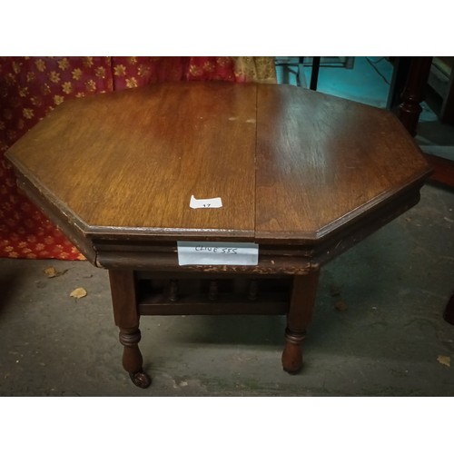17 - Lovely octagonal oak side table on casters with middle display shelf