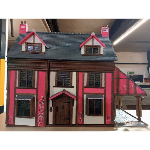 264 - Incredible tudor style dolls house with double front opening, beams on the ceiling, fireplaces in mo... 