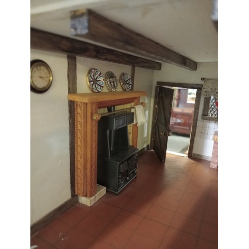 264 - Incredible tudor style dolls house with double front opening, beams on the ceiling, fireplaces in mo... 