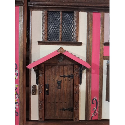 264 - Incredible tudor style dolls house with double front opening, beams on the ceiling, fireplaces in mo... 