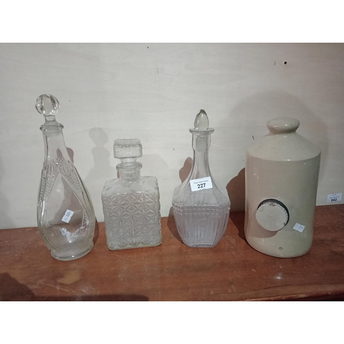 227 - Lovely selection of 3 glass decanters with stoppers together with an earthenware bedwarmer