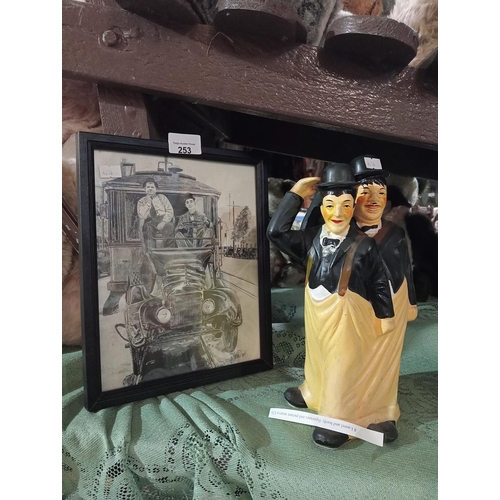 253 - Laurel and Hardy ceramic figurine with black and white framed picture