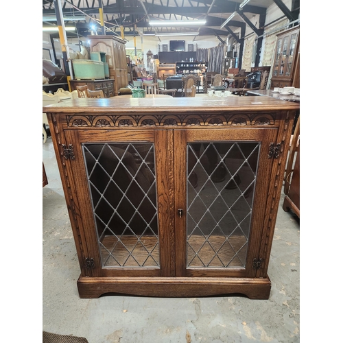 787 - Oak display cabinet with leaded glass doors