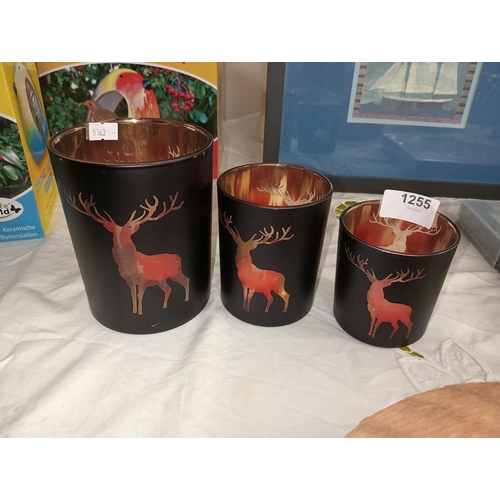 1255 - 3 beautiful black and gold tea light holders with the image of a reindeer