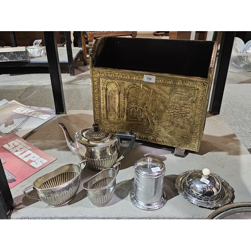 108 - Embossed brass and wood magazine rack together with a plate teapot with matching sugar bowl and jug.... 