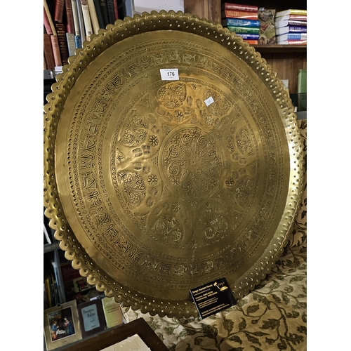 176 - Really large and decorative embossed brass plate, measures approx 57cm across