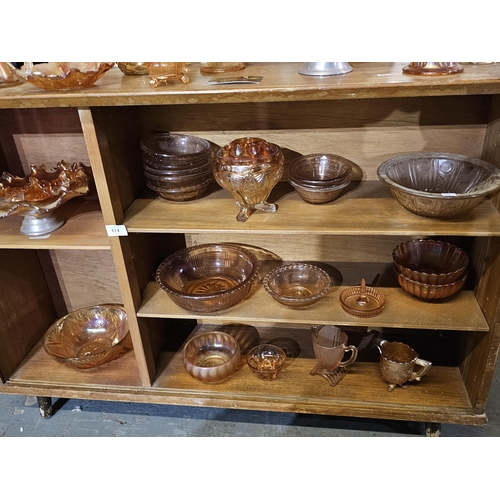 174 - large collection of amber coloured glass bowls, vases and jugs, some of which are lustre ware