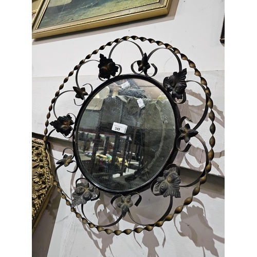 349 - Lovely circular mirror with a twisted metal surround with a leaf pattern