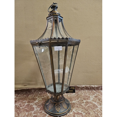 1 - A large copper coloured metal lantern, tapering octagonal shape, with decoration in relief. 70cm hei... 