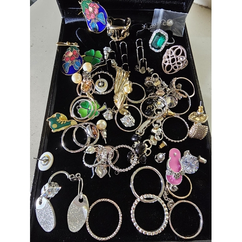 365 - Large collection of Vintage and modern costume jewellery, including rings and earrings and badges.