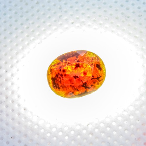 666 - Gemstone with red hue, 2nd photo taken with light behind