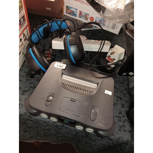 1182 - Nintendo 64 games console together with Ozeino headphones, assorted electrical leads and a 4-way ext... 