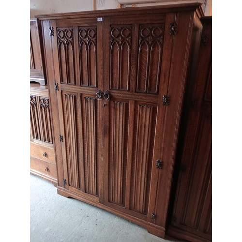 1395 - CROWN FURNITURE,ANTIQUE QUALITY SOLID DARK WOOD DOUBLE WARDROBE, WITH CARVED GOTHIC DETAIL. METAL DO... 