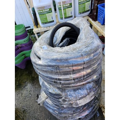 398 - LARGE LOT OF PLASTIC COILED PIPE