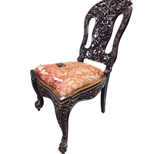 119 - Hall chair with ornately carved back. Has had some restoration