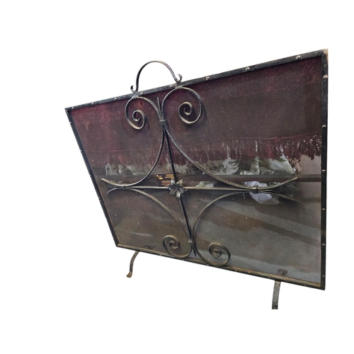 117 - Large wrought iron and mesh fire guard, measuring approx 92 x 77cm