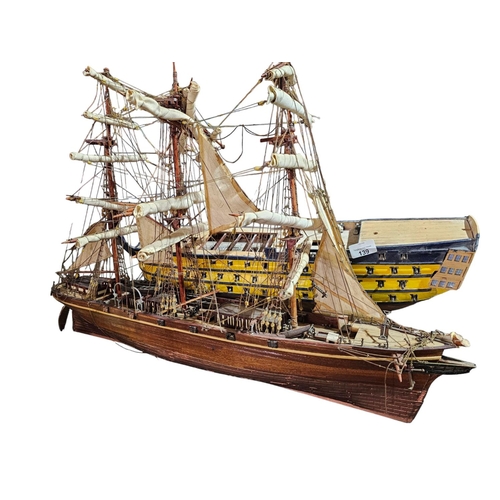 139 - Pair of intricate wooden boat replica models. The sailboat is approx 29