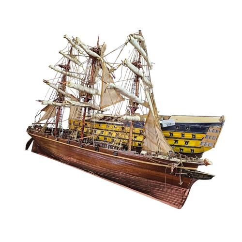 139 - Pair of intricate wooden boat replica models. The sailboat is approx 29