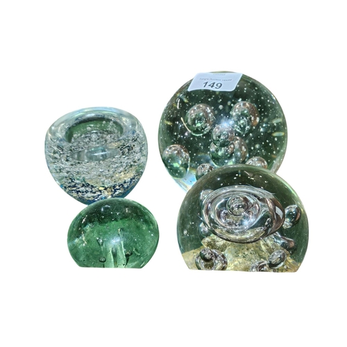 149 - A collection of assorted size glass bubble paperweights, one of which can be used as a tealight hold... 