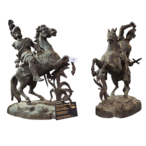 48 - A pair of spelter figures depicting soldiers on horseback