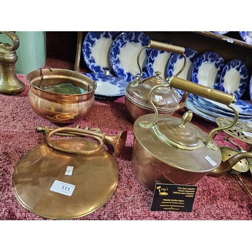 111 - Brass and copper collection to include 2 kettles, a hanging pot, a decorative plate and a bugle