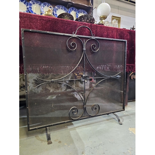 117 - Large wrought iron and mesh fire guard, measuring approx 92 x 77cm