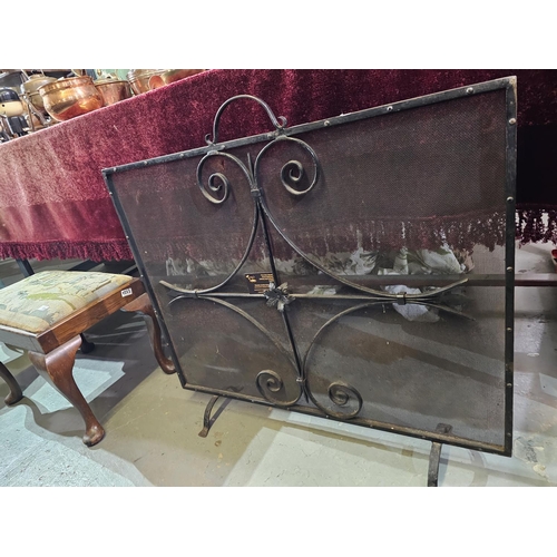 117 - Large wrought iron and mesh fire guard, measuring approx 92 x 77cm