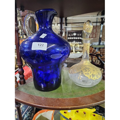 122 - Heavy blue glass jug with clear glass handle together with decorative Italian glass bottle with stop... 