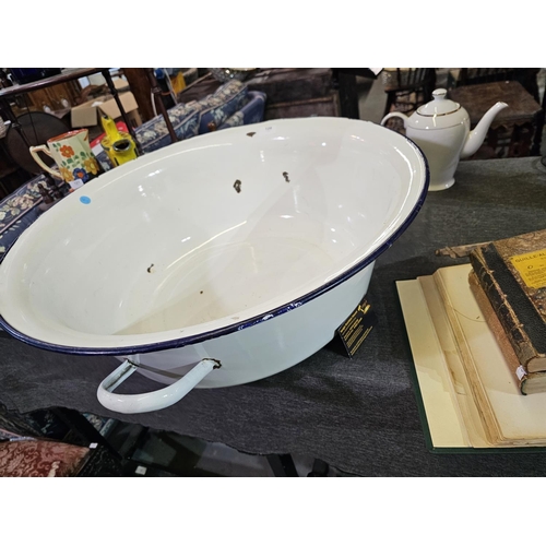 128 - Large oversized enamel basin with handles. Approx 64cm across.