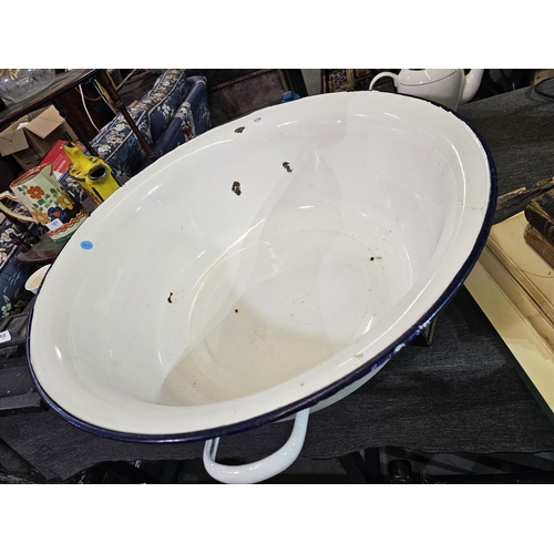 128 - Large oversized enamel basin with handles. Approx 64cm across.