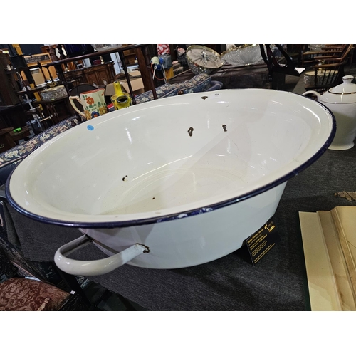 128 - Large oversized enamel basin with handles. Approx 64cm across.