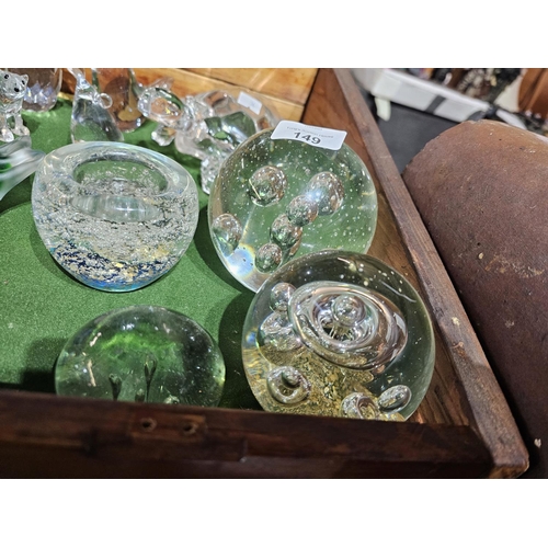 149 - A collection of assorted size glass bubble paperweights, one of which can be used as a tealight hold... 